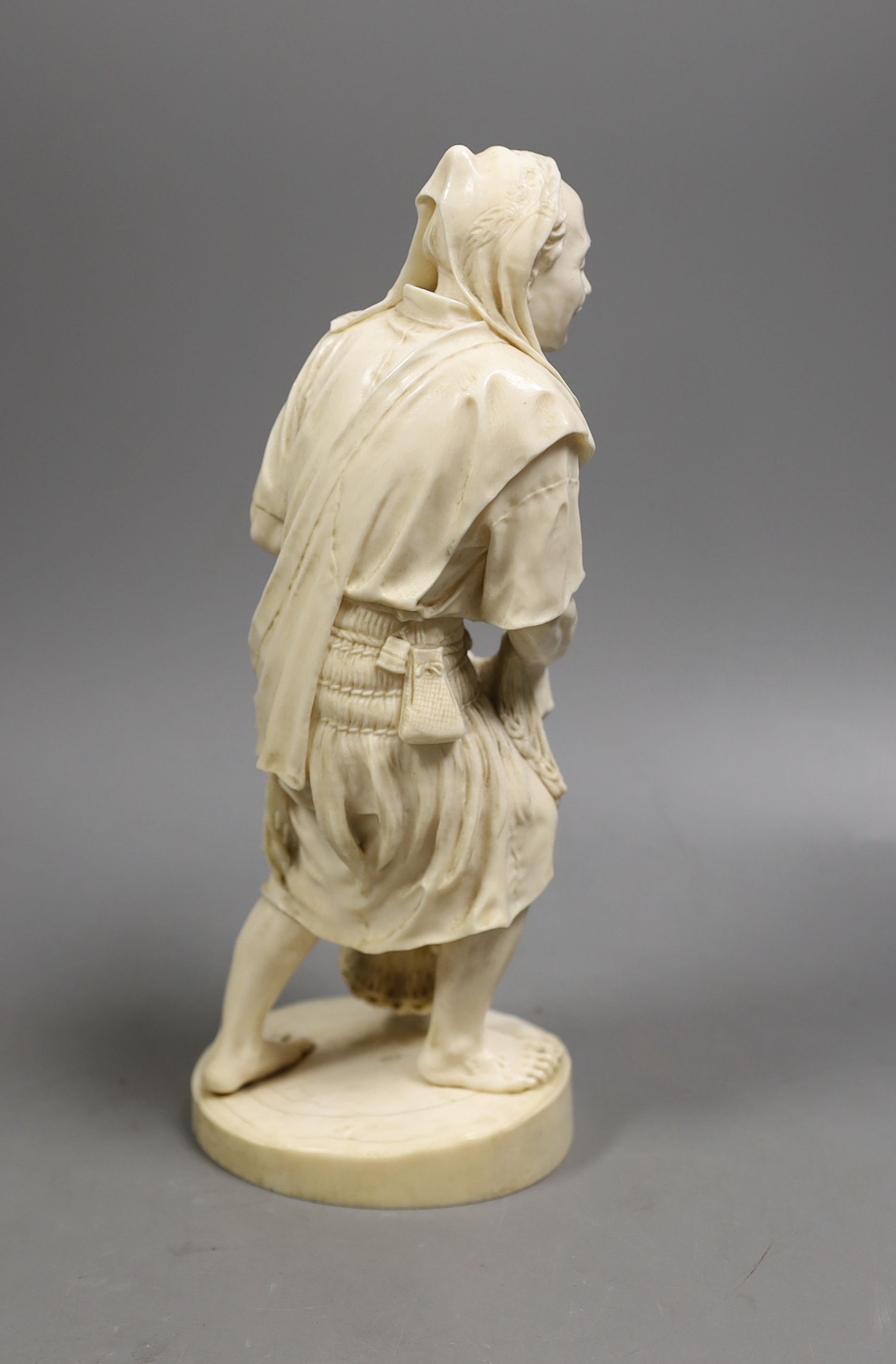 A large Japanese Tokyo School ivory figure of a fisherman, signed, Meiji period, 26 cms high.